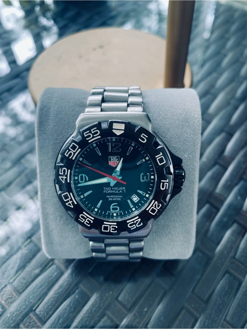 Tag Heuer stainless steel watch with black dial and red seconds hand